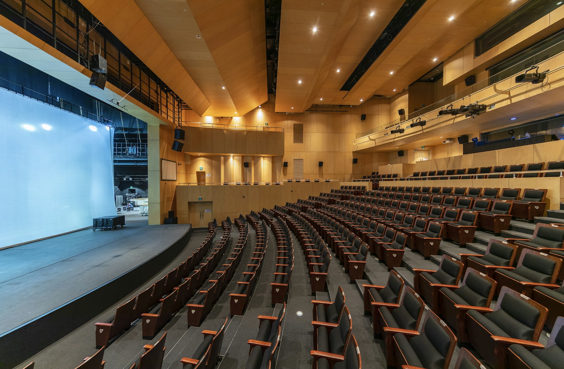Auditorium with tiered seating and a projection screen