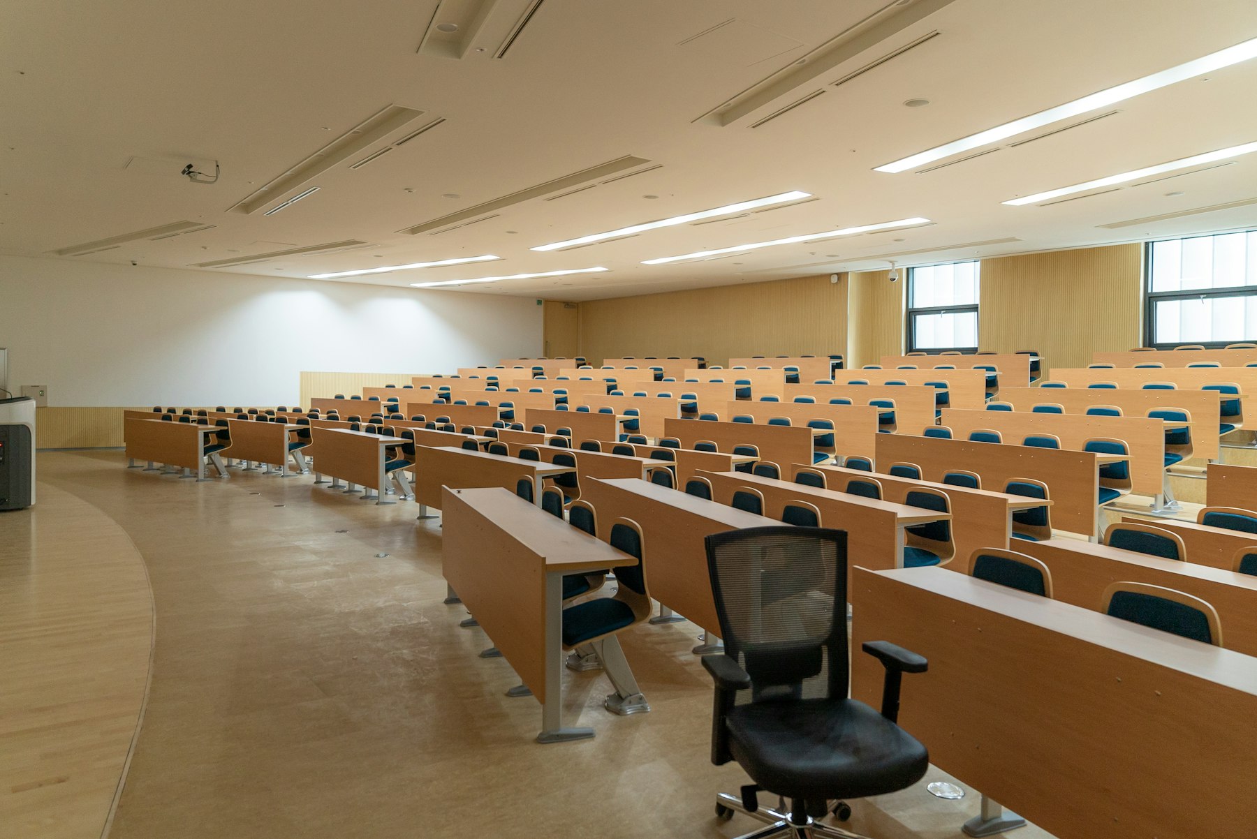 Modern lecture hall with rows of desks